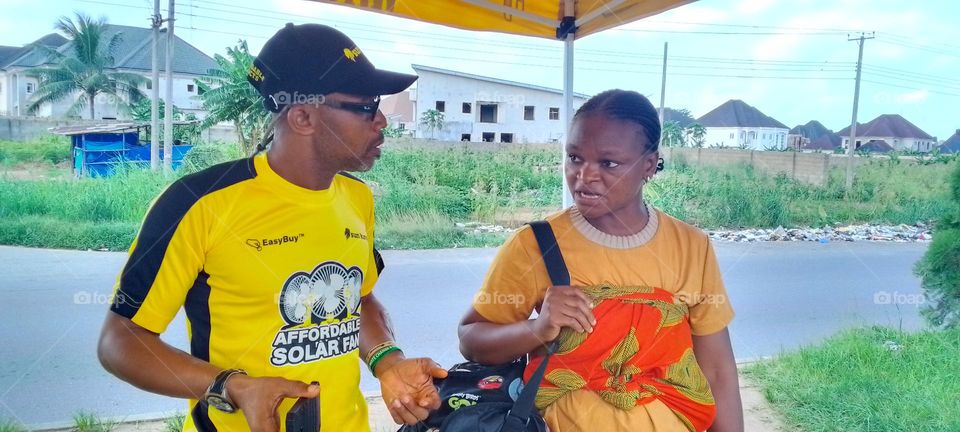 here's a Friend Aniefiok , a Sun king Agent talking with a prospect in ikot Akpan abia community in Uyo