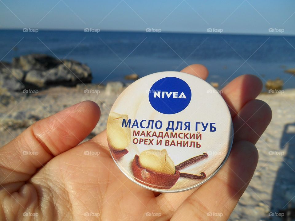 nivea in hand on the sea