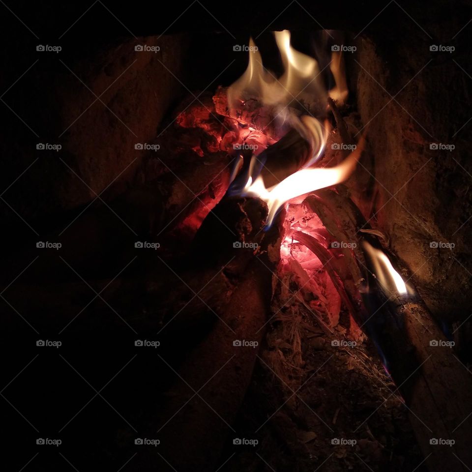 A close-up photo of the fire smoldering and blazing.