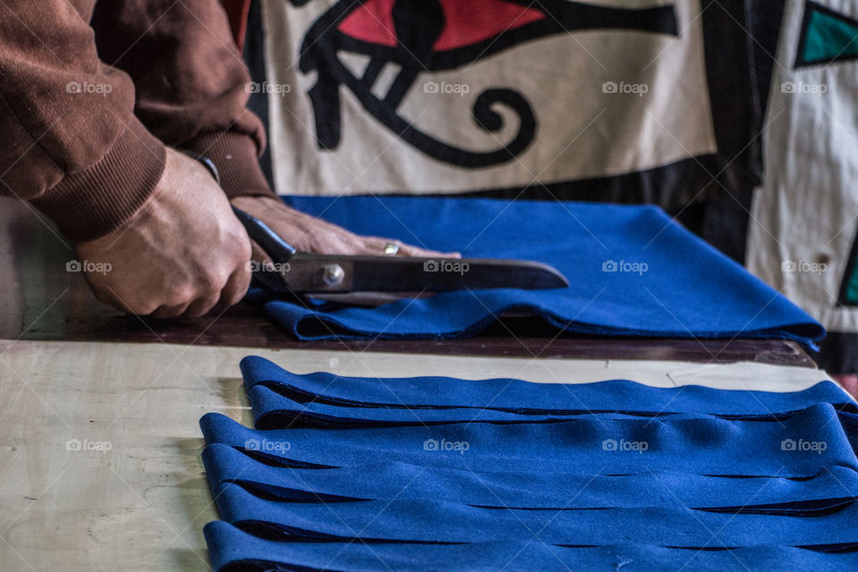 Staying in his own shop cutting this textile and taking measurements. I posted different stages. I was lucky to get there while he was just starting.