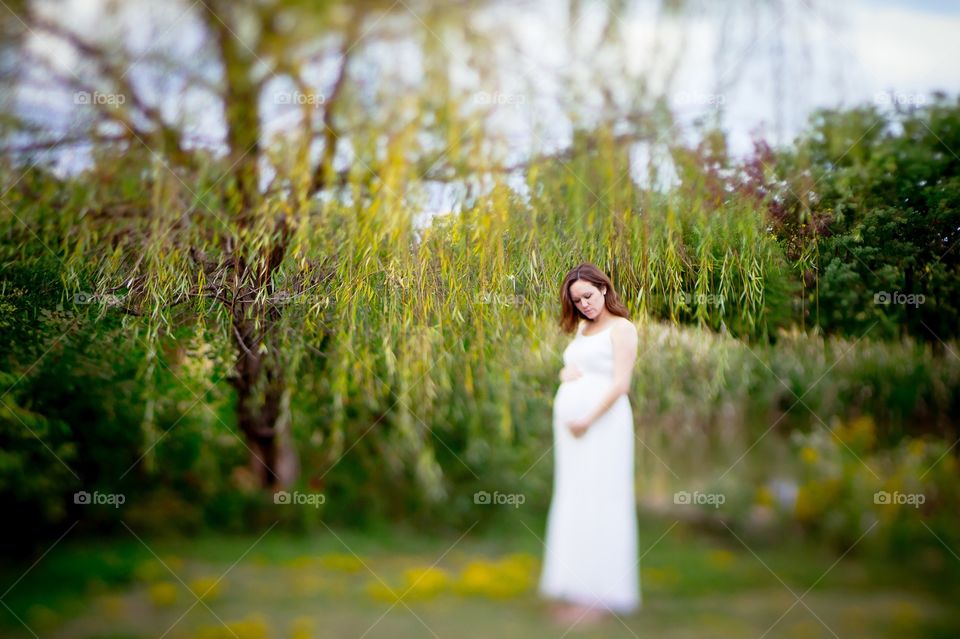 Pregnant woman standing in park