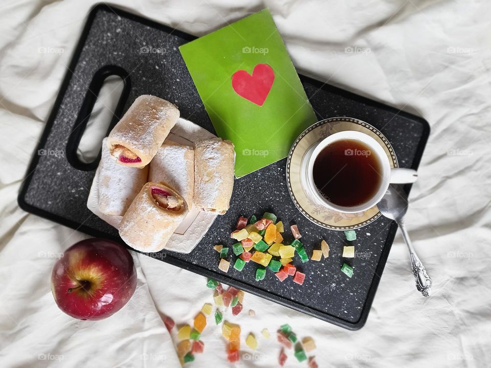 time to drink coffee! a cup of aromatic coffee, strudel with cherry jam, candied fruits and an apple!