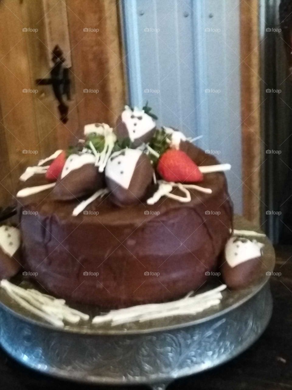 delicious chocolate on chocolate cake with tuxedo strawberries