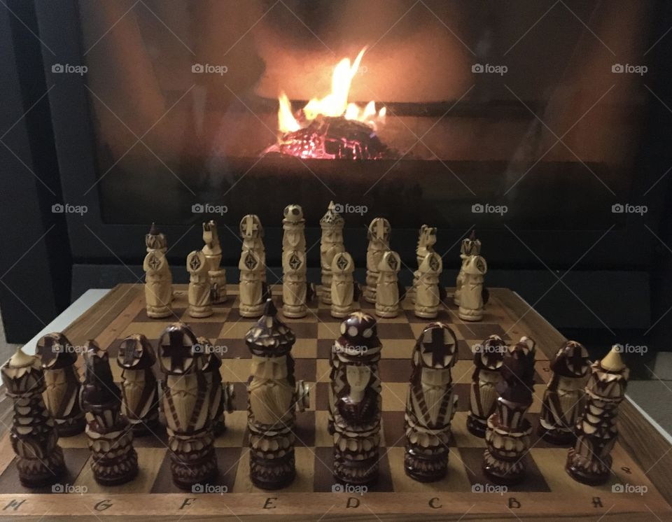 Chess game before the fireplace 