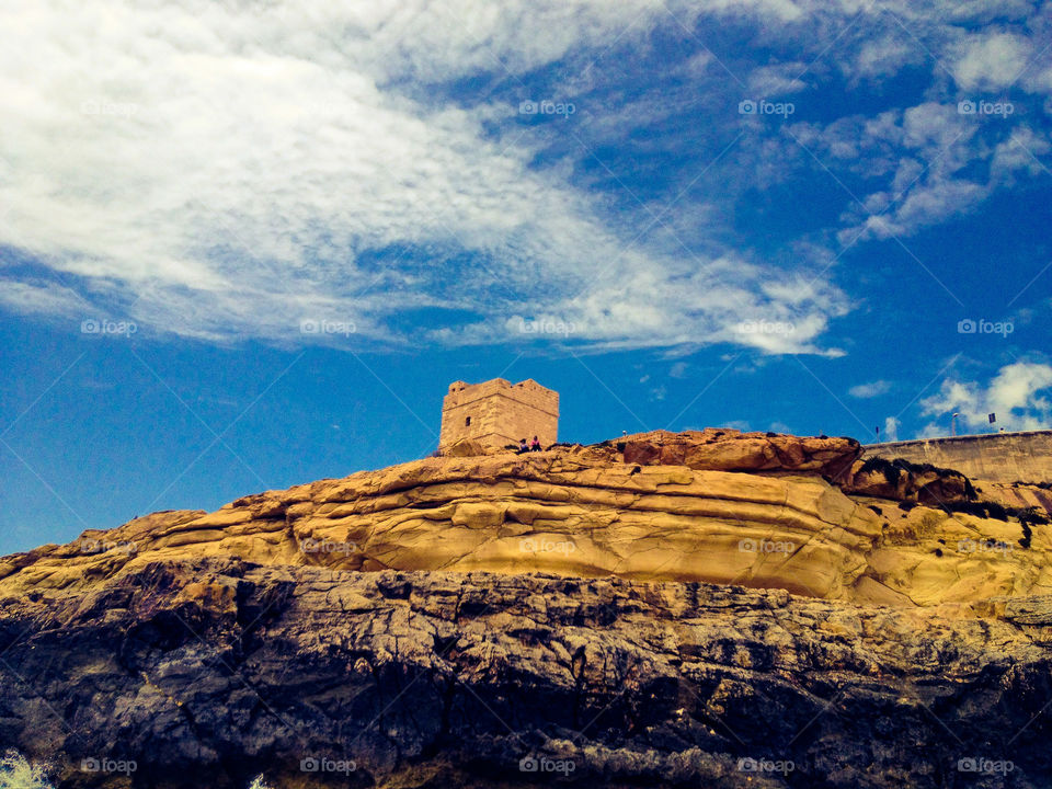 Tower over a cliff, taken from the boat ride from the island of Comino, Malta.
