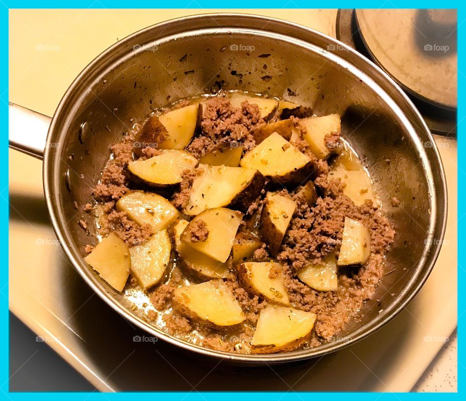 Late night cooking. It is ground turkey and potatoes prepared for supper.