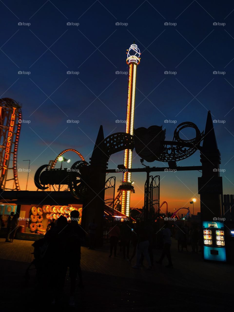 A beautiful night at Coney Island.  Vibrant orange, blue and purple hues and the lights of the rides.