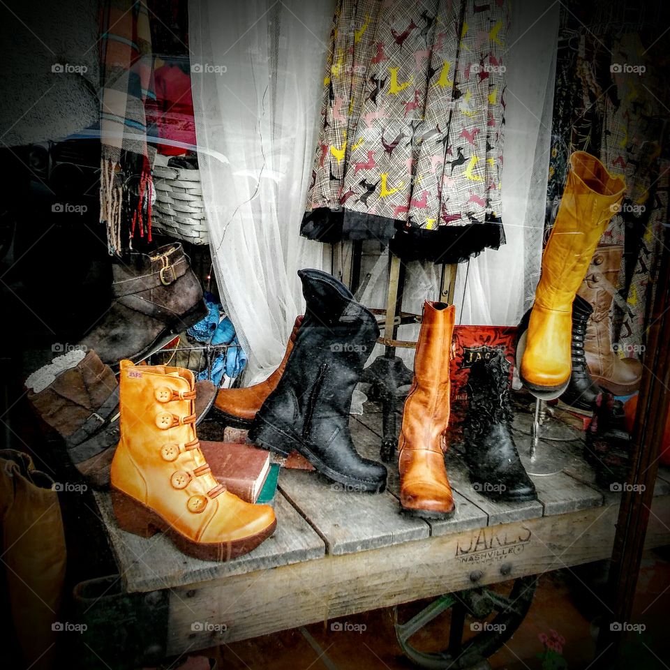 Window display of artisan- made clothing and foot wear.