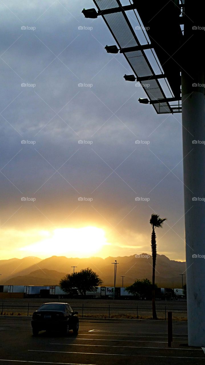 sunset in the desert. storm clouds chasing the setting sun