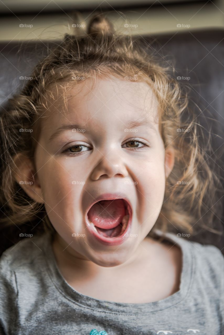 Close-up of child girl with mouth open