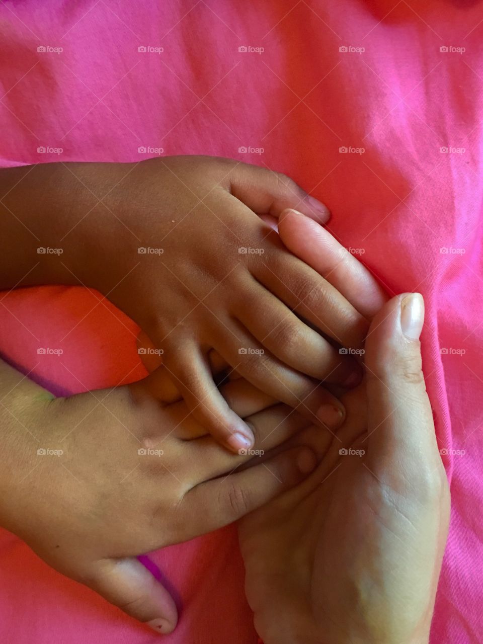 Three hands ages 2,7, and 40. Holding each other forever.