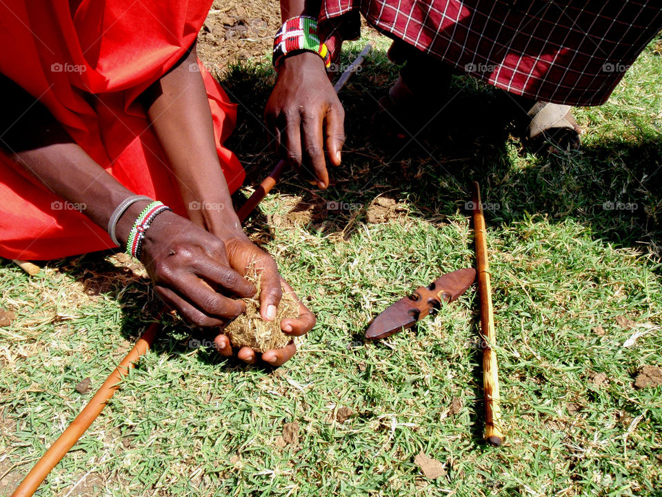 Maasai men making fire