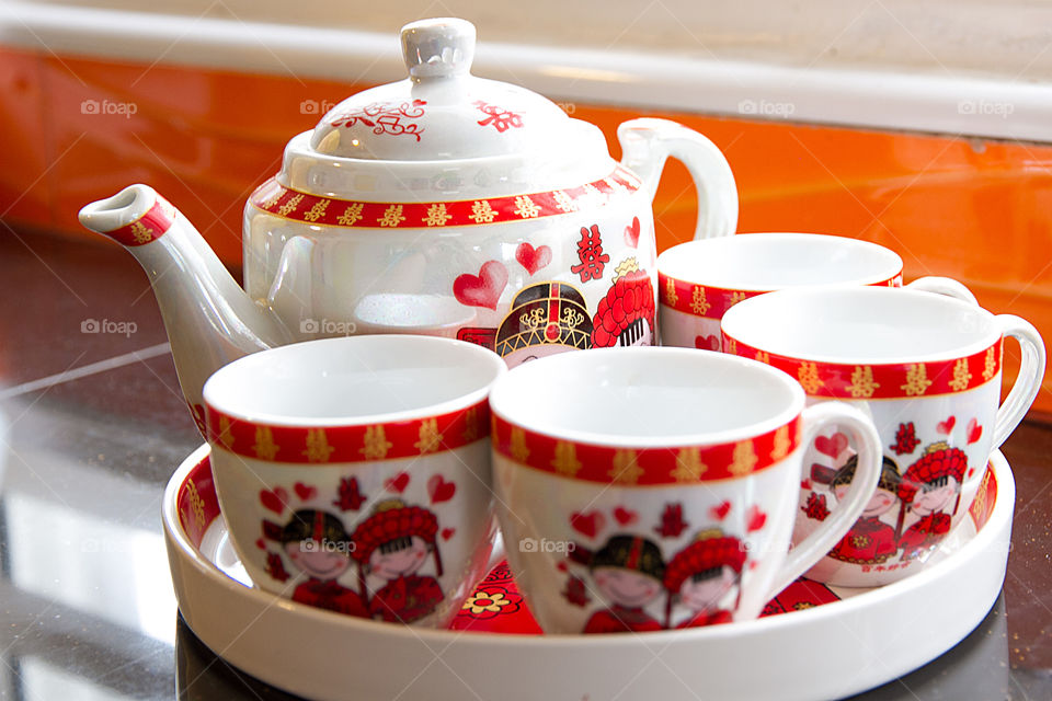 Close-up of tea cup and tea pot