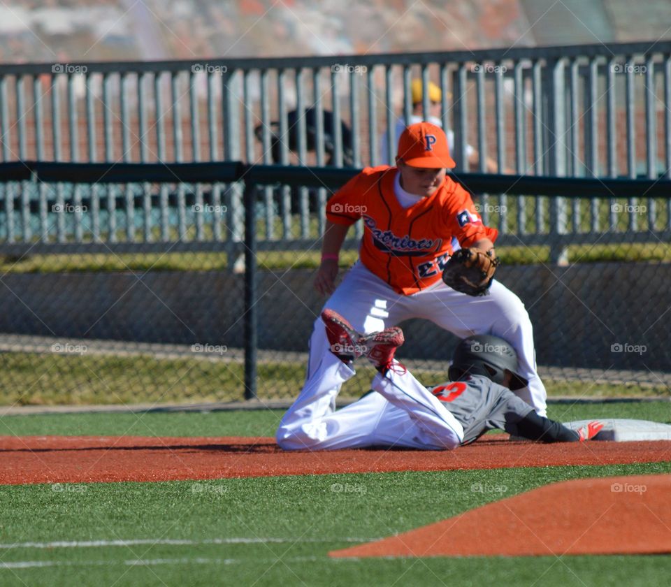 Youth baseball game. Safe at 1st. 