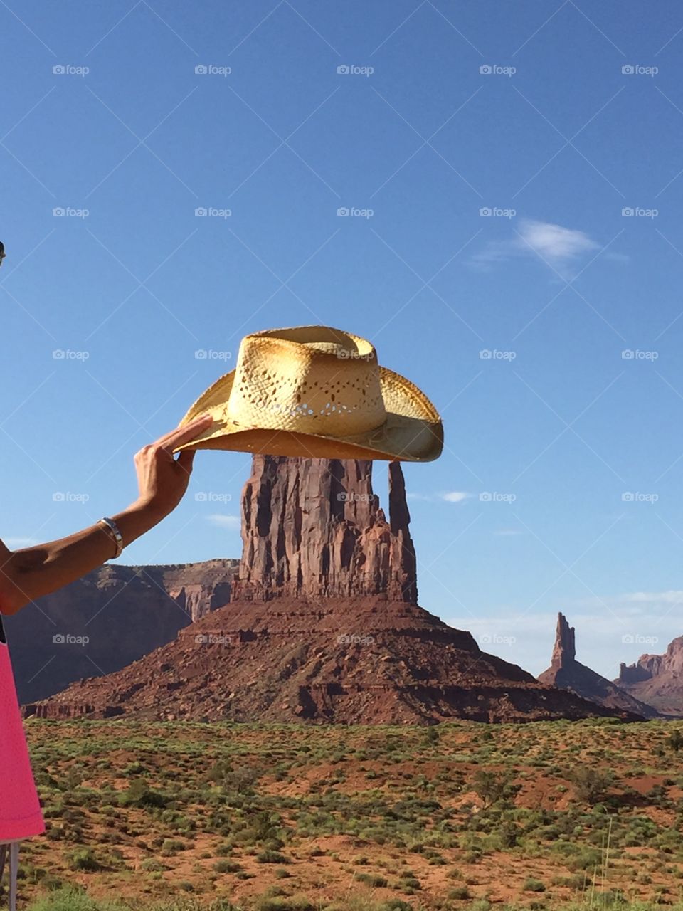 A sandstone of the monument valley that wearing a cowboy hat