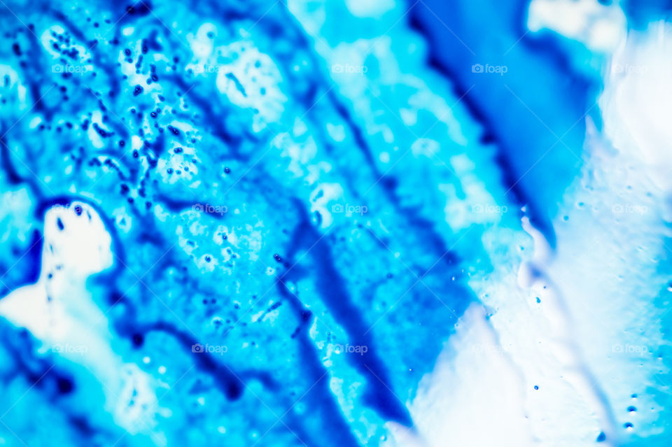 The ink to refill the printer cartridge was spilled onto the white washbasin and the paints blended into abstract drips and patterns.