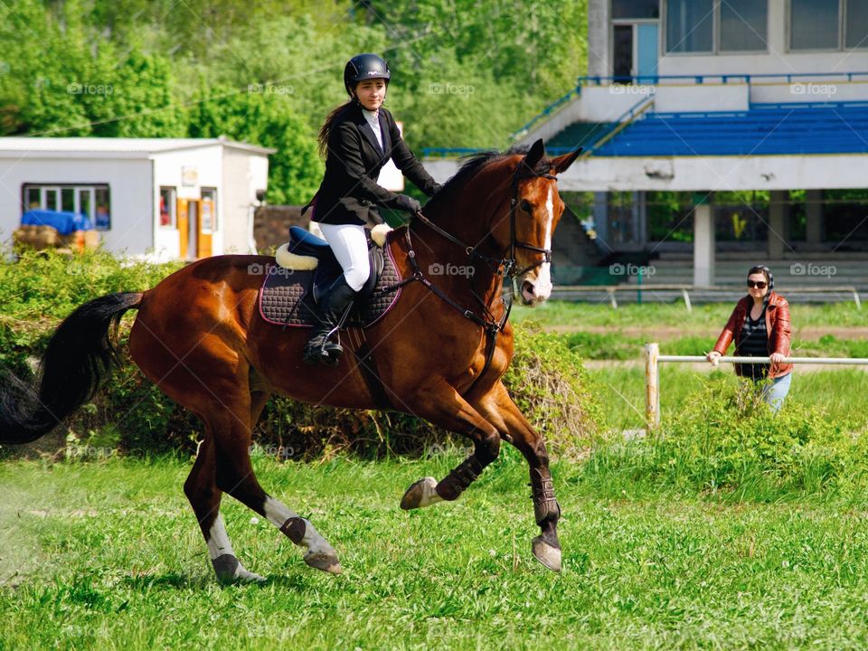 Young woman riding the horse