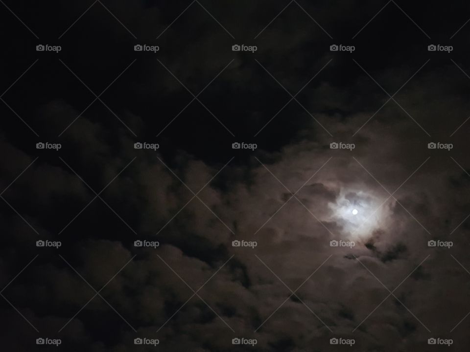 The moon in clouds at night