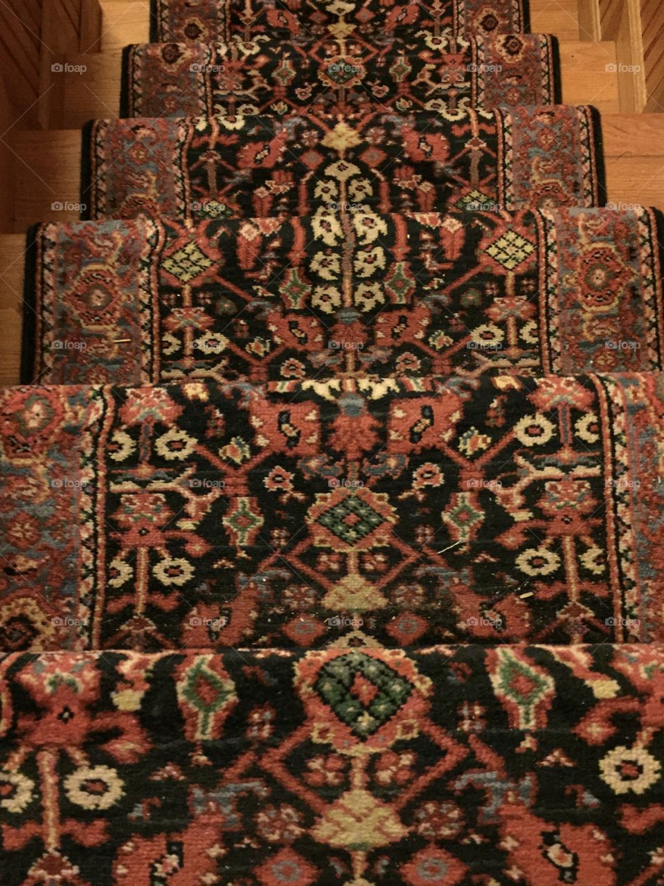 Staircase with a red traditional rug