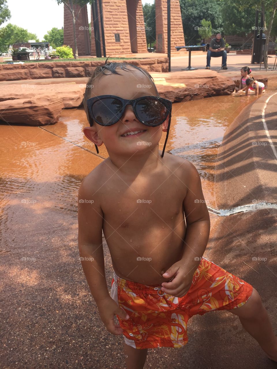 Boy wearing sunglasses at the water park