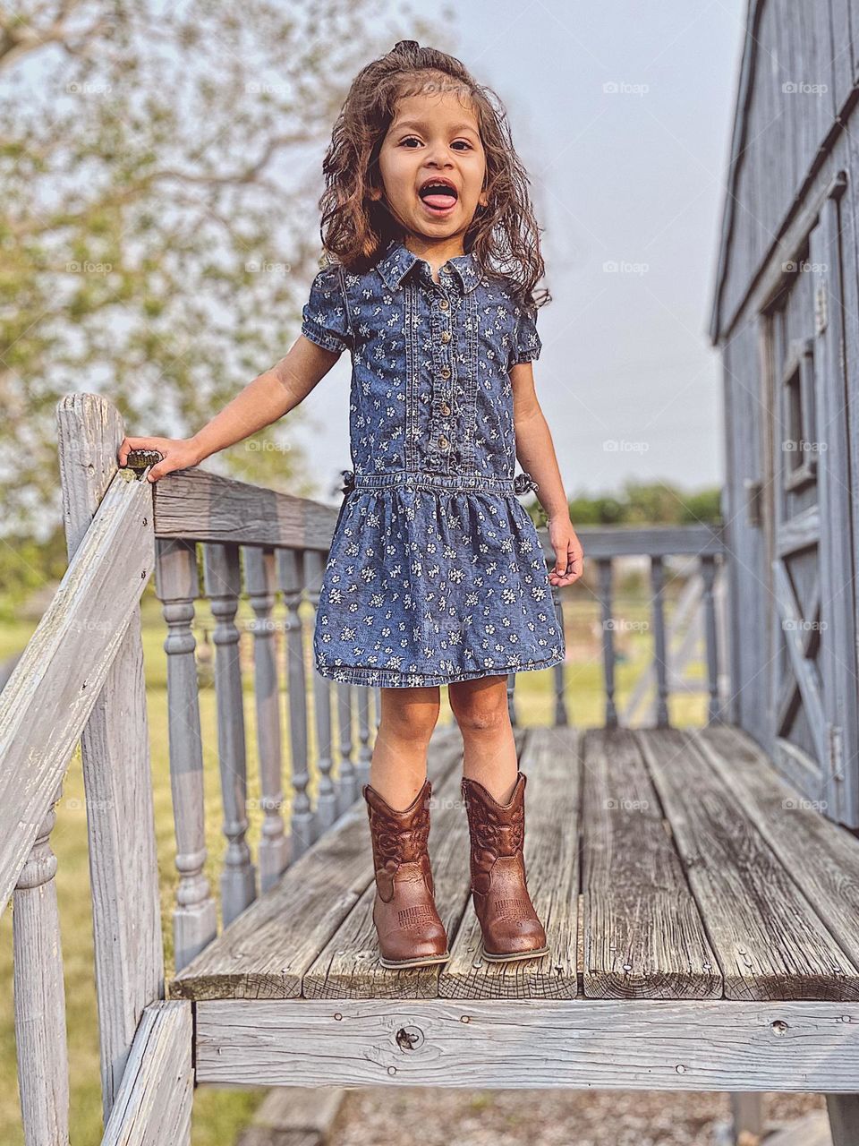 Summertime on the playground with a toddler, playing on the playground in the summer, toddler girl wearing summer dress and cow boy boots, cowboy boots on toddlers, summer in the Midwest 