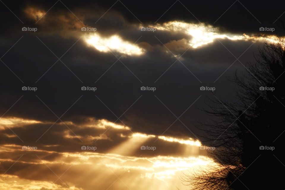 Clouds that look like an evil face with sunrays.