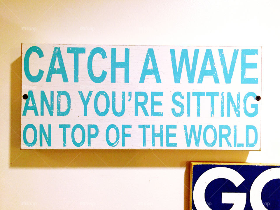 Sign in a surf bar and grill. Catch a wave in your sutting on top of the world.