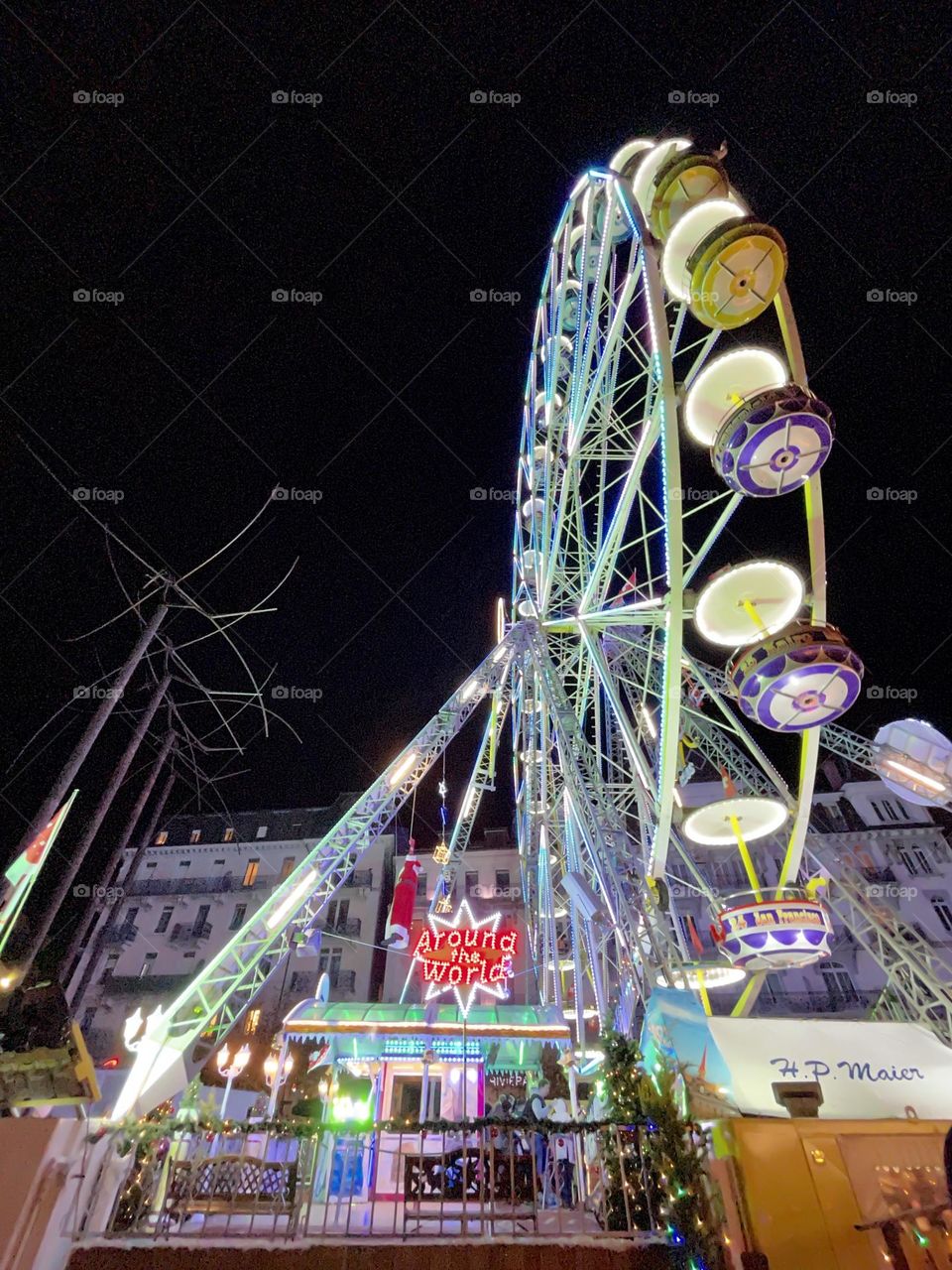 Ferris wheel at night, in the dark, black background in Montreux, Switzerland, Luna Park setting 