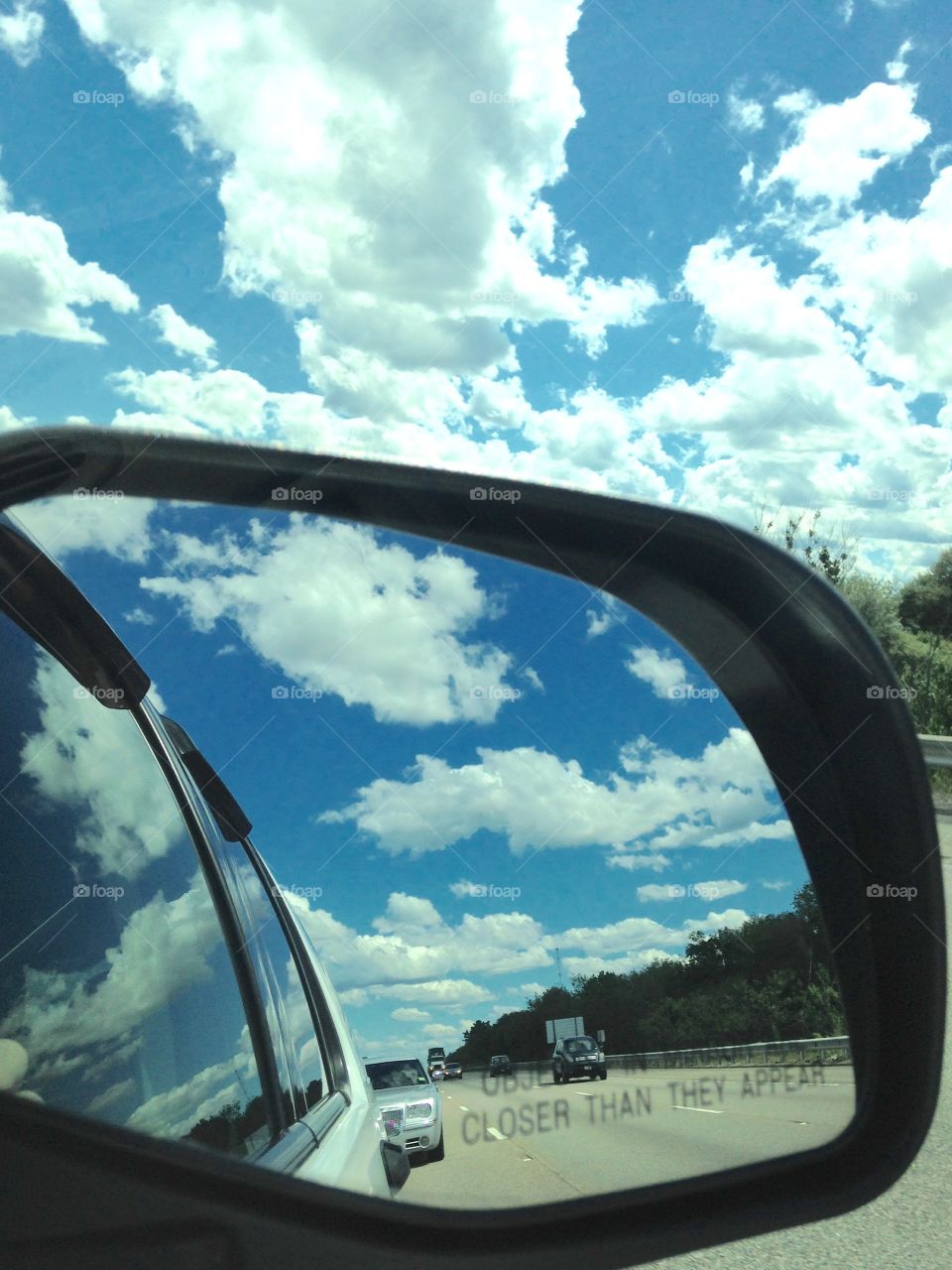 Rear View Mirror Clouds & Sky. Clouds in Rear View Mirror, Sky, Reflecting on Car. Amazing picture. Glad for my IPhone! Blue sky, white fluffy clouds.