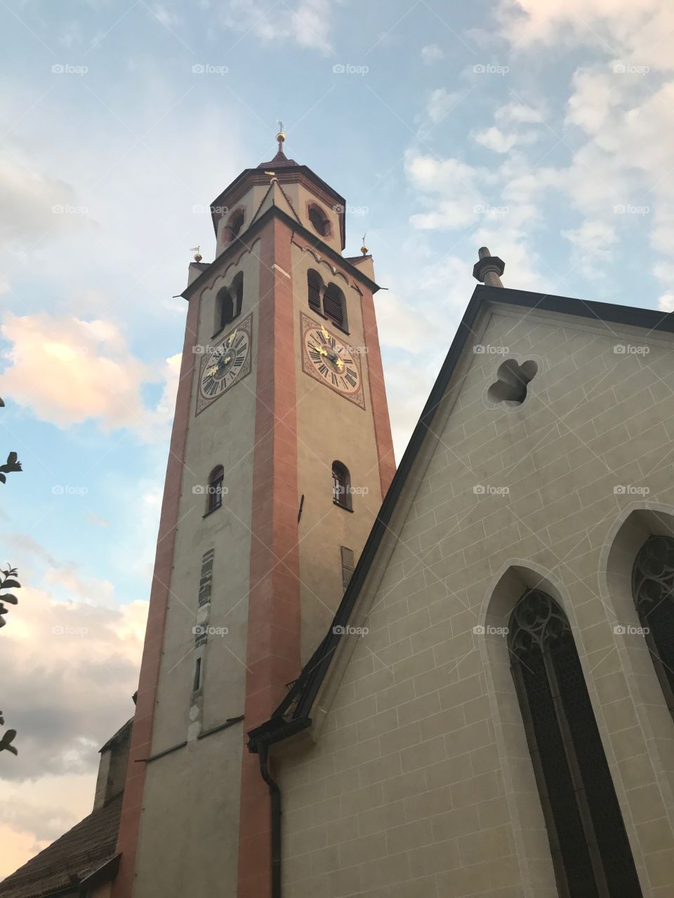 At sunset, the sky has many beautiful colors , a church in beautiful town , stand out amidst the colorful sky