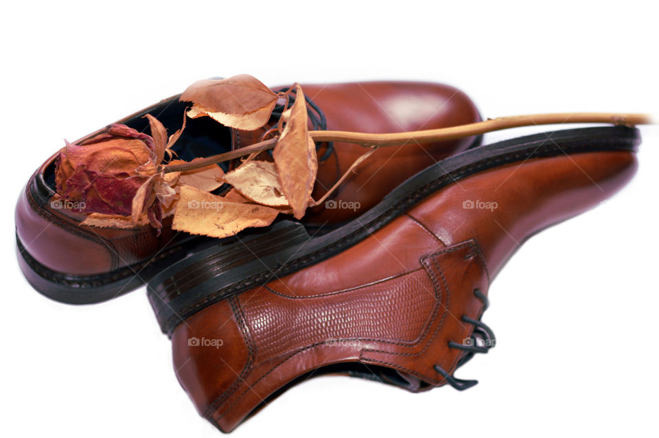 Man shoes with dried rose on top