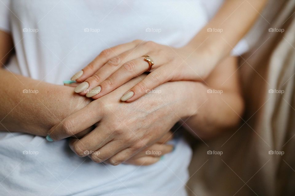 Hands of mother and daughter