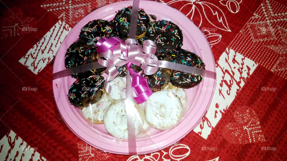 Graham balls and white donuts in a pink Easter-theme package on a red heart-patterned tablecloth