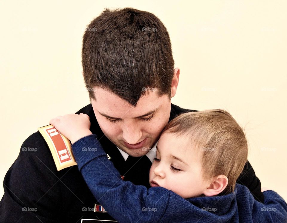 Toddler son giving his father a hug 