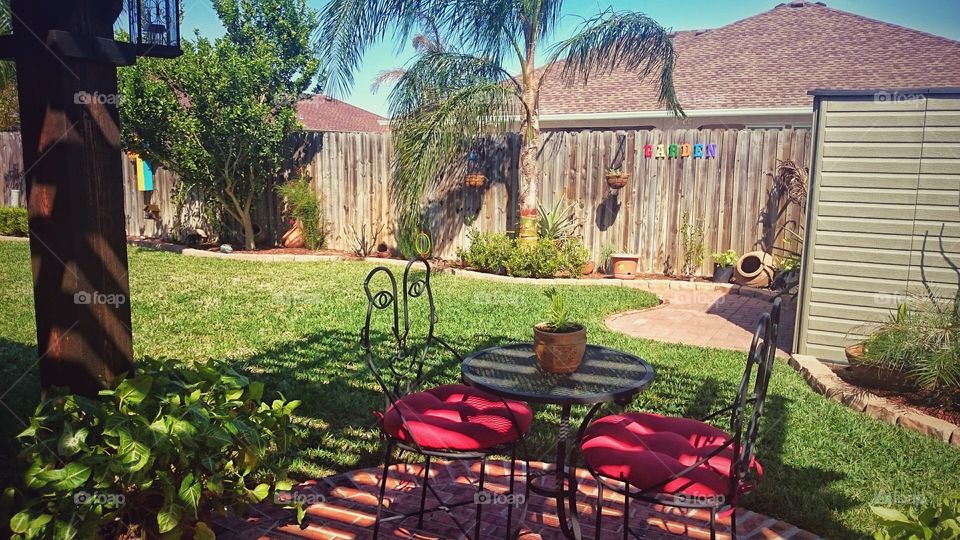 spring is in the air backyard patio red bistro table and chairs garden yard purgala trees south Texas