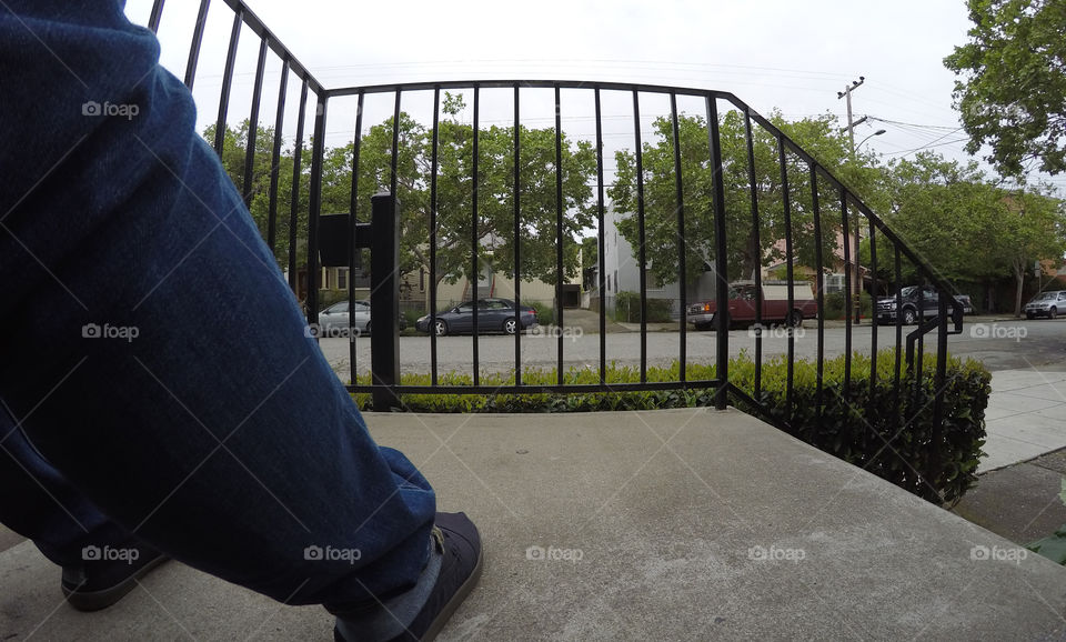 Sitting on stoop in Oakland by Stairway. Street view.