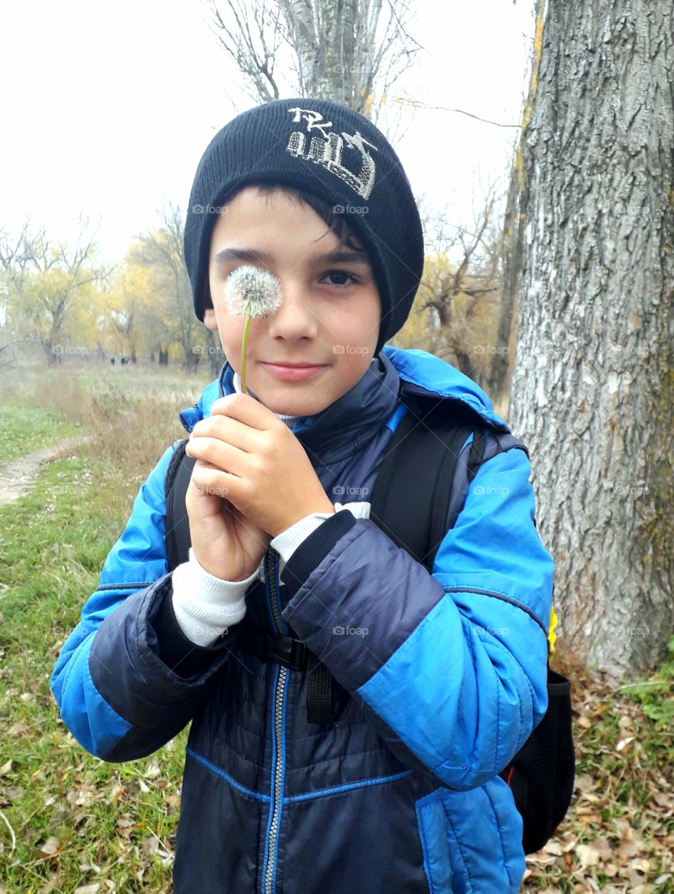 a boy with dandelion