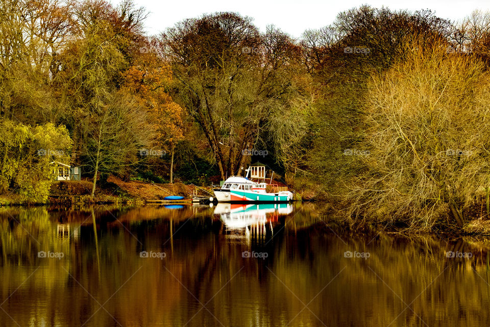 Beautiful reflection shot of boat on river with no people 