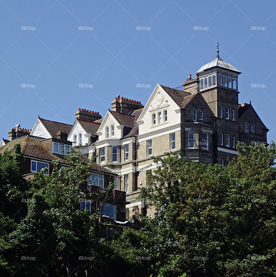 An old hotel sitting on a hill in Folkestone England on a sunny summer day. 
