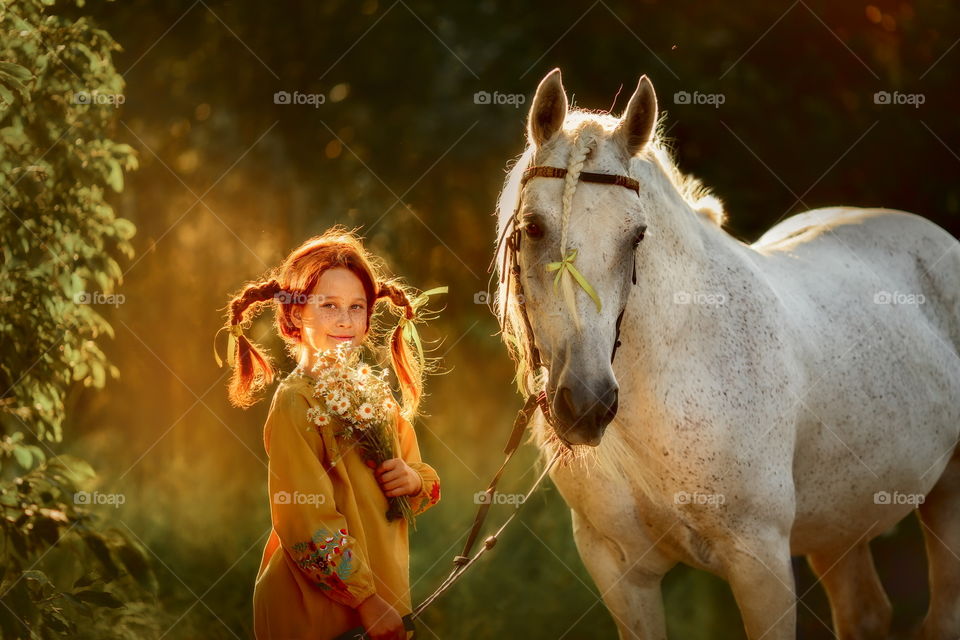 Funny red haired girl with white horse