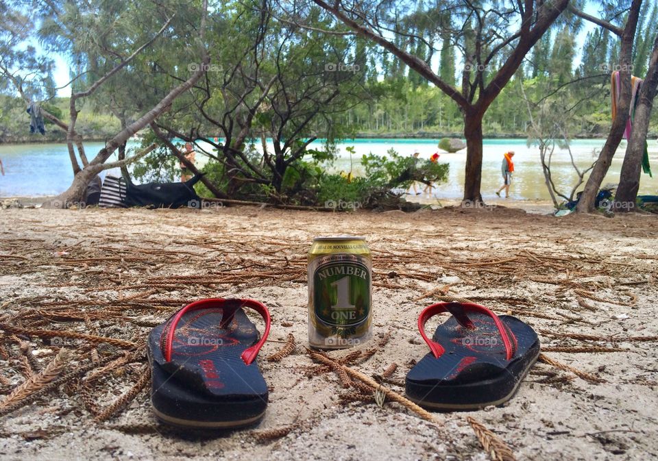 Beer and tong on an island of the most beautiful lagoon of the Pacific. In New Caledonia