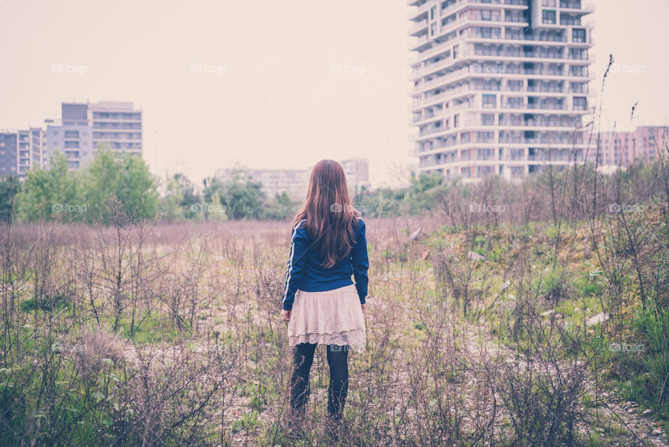 back woman looking desolate landscape