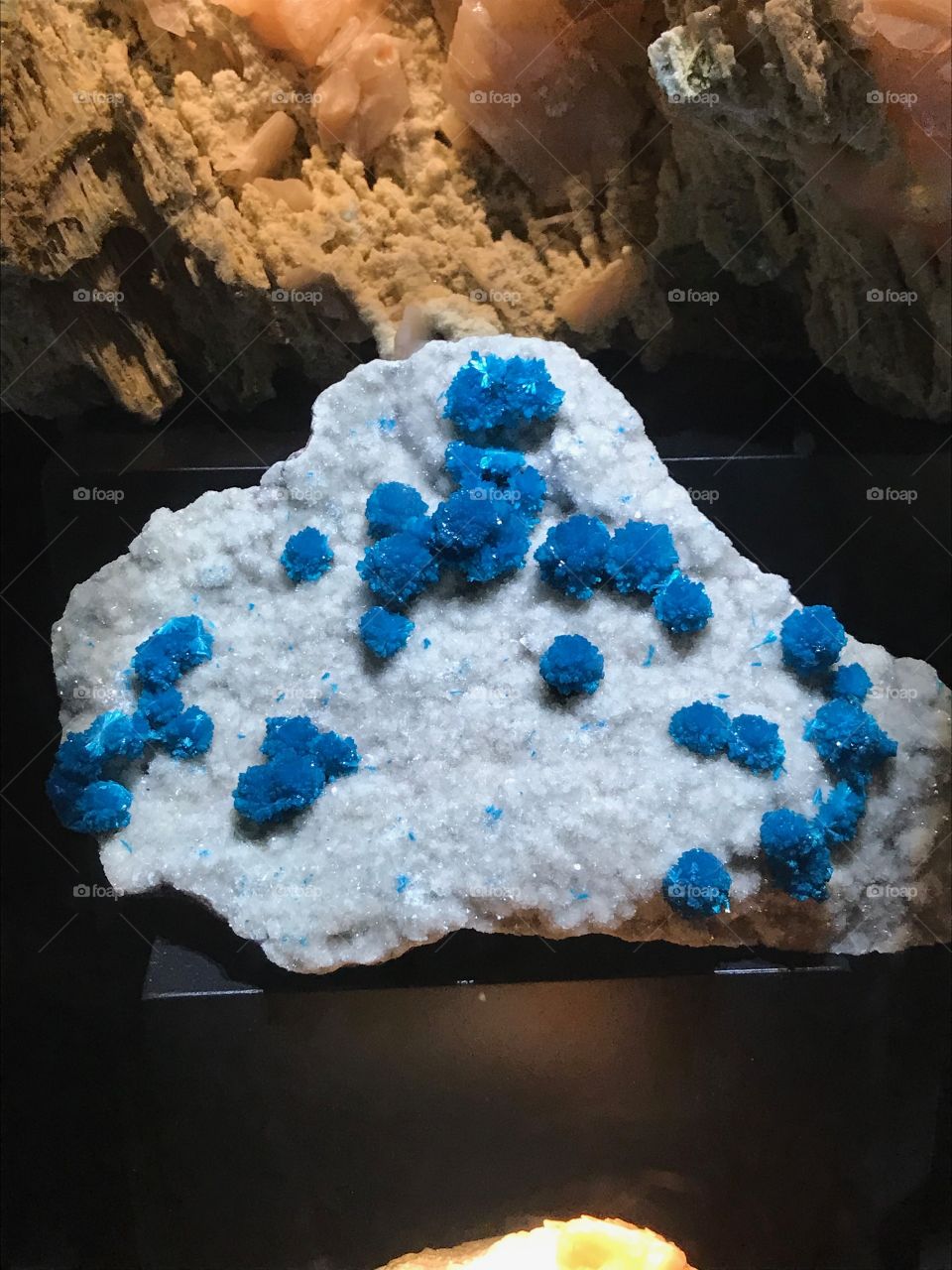 Blue crystal clusters on white crystalline structure 