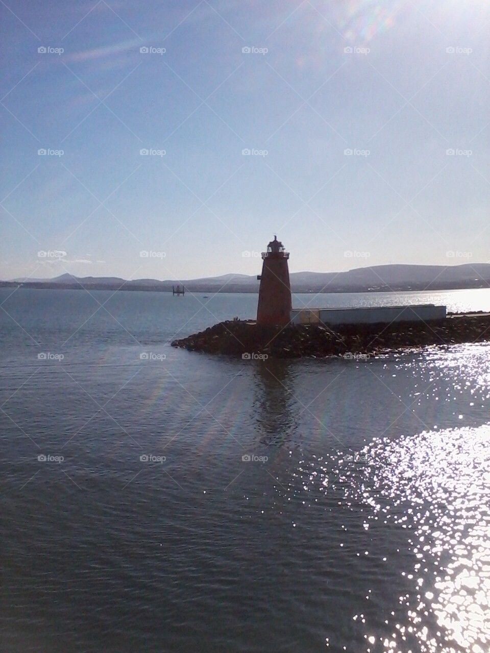 Sun over lighthouse