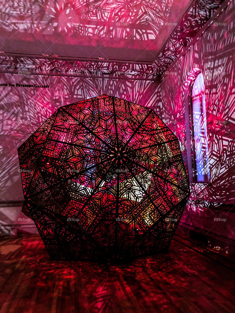 An artistic light sphere casts geometric shapes on the walls at the Renwick Gallery in Washington DC