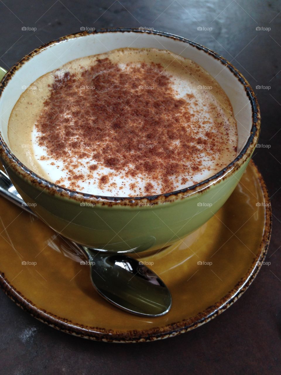 Coffee. Cup of coffee with milk and cinnamon powder 