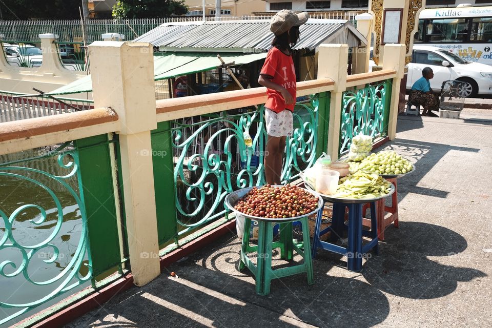 A kid selling fruits