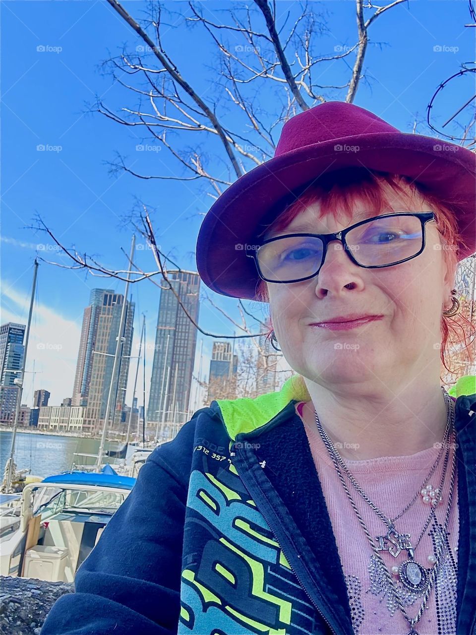 This is me, “Petra Schiller” a.k.a. “Maxine Firefox” standing by the wall we walk along to get to our boat “Salvation” in the parking lot beneath the “Pulaski Bridge” at “Newtown Creek”. 2024. Hypnotic Productions