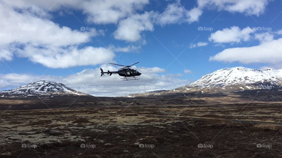 Helicopter taking off between the mountains in Iceland 