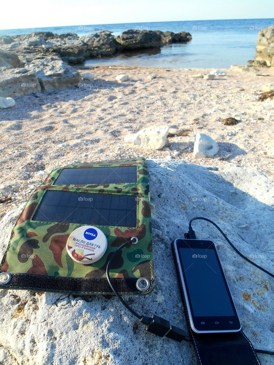 solar panel and nivea rest on the sea shore